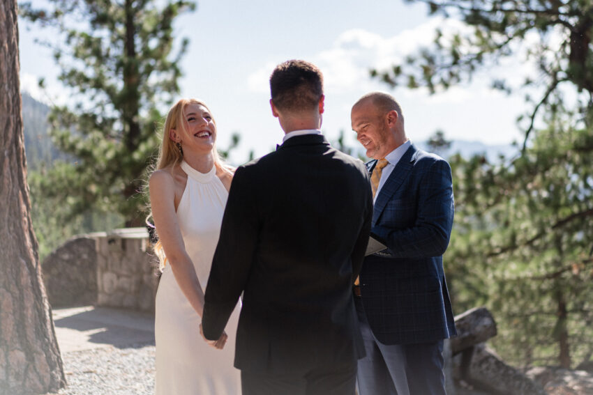 Bride laughing during the wedding ceremony overlooking Lake Tahoe.