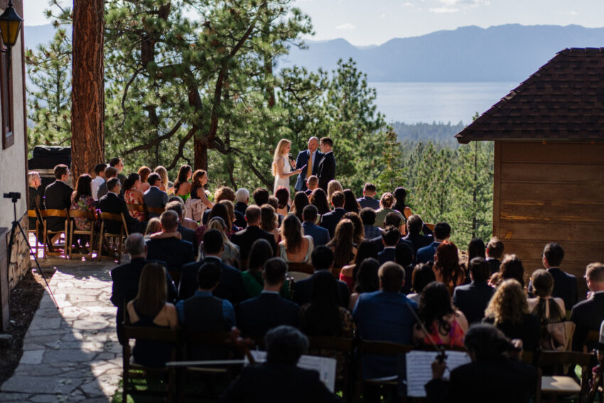 Guests watching the ceremony with Lake Tahoe and mountain views behind.