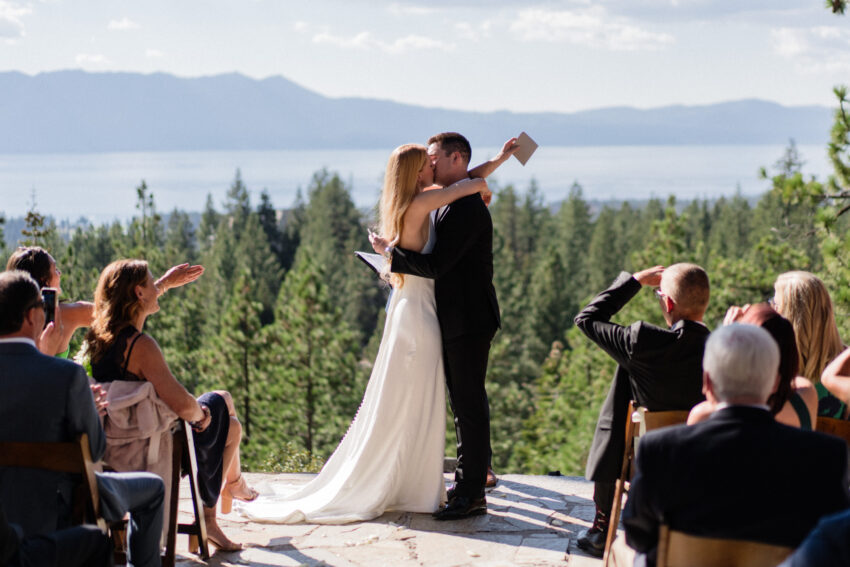Bride and groom sharing their first kiss after the ceremony at Tahoe Mountain Home.