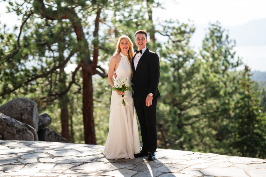 Bride and groom standing together after their wedding overlooking Lake Tahoe.