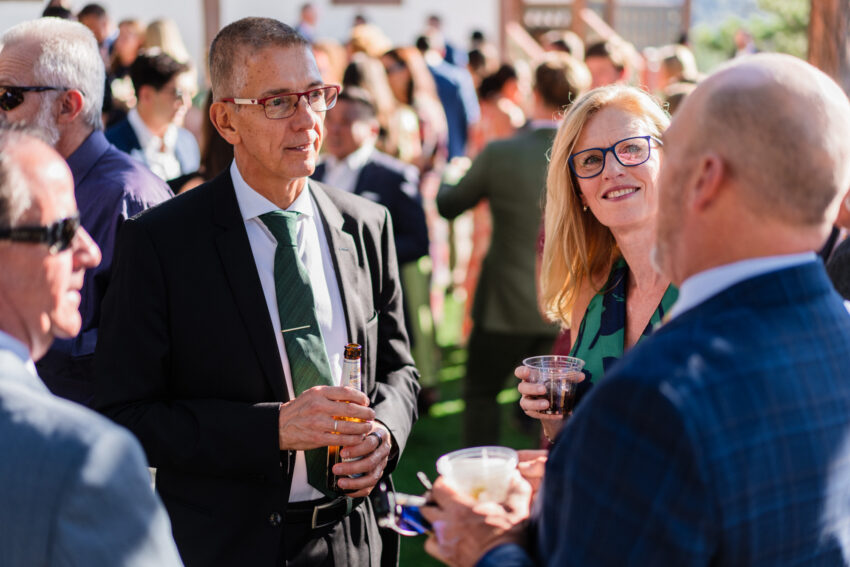 Guests chatting and enjoying drinks during the wedding reception at Tahoe Mountain Home.