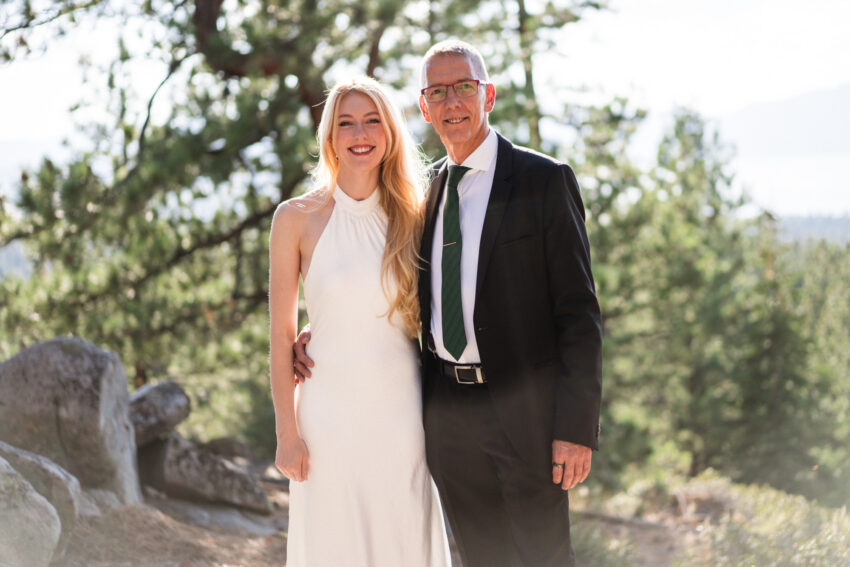 Bride posing with her father outdoors at Tahoe Mountain Home overlooking Lake Tahoe.