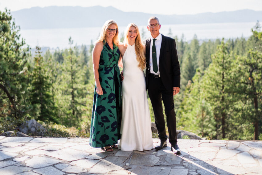 Bride with her parents after the ceremony with Lake Tahoe views behind them.
