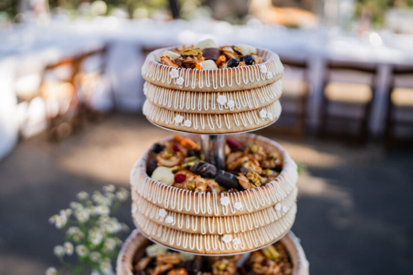 Wedding dessert tower with fruit and pastries displayed at the reception.