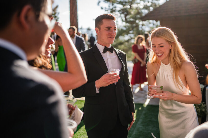 Guests enjoying drinks and conversation during the outdoor reception at Tahoe Mountain Home.