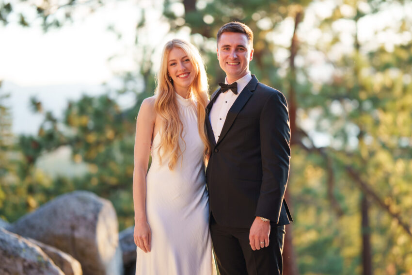 Bride and groom portrait together at Tahoe Mountain Home with forest and Lake Tahoe views behind.