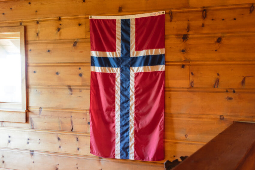 Norwegian flag hanging inside the wooden cabin at Tahoe Mountain Home.