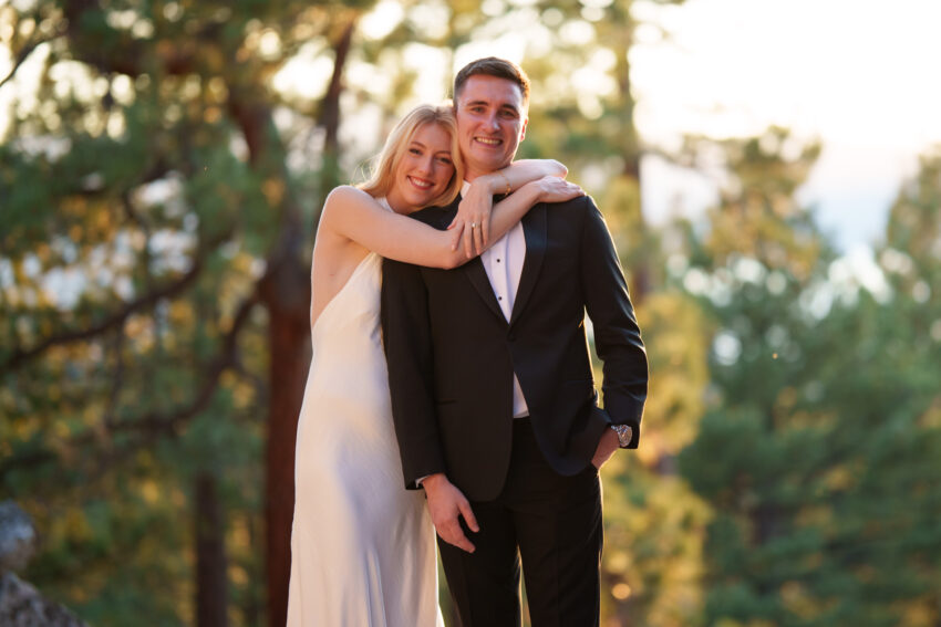Bride embracing the groom during golden hour portraits overlooking Lake Tahoe.