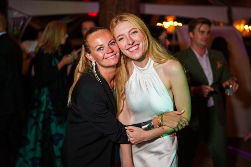 Bride hugging a guest on the dance floor during the evening wedding party.