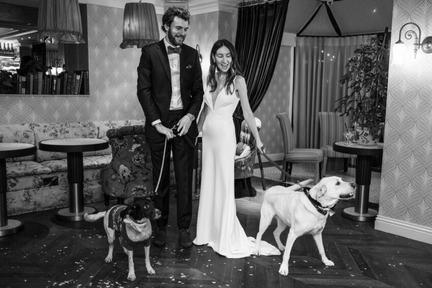 Bride and groom with their dogs during the reception at The Graduate Cambridge wedding venue.