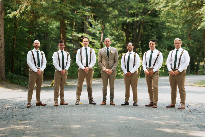 Groom and groomsmen standing together on a woodland road at Trillium Resort & Spa in Muskoka, Ontario.