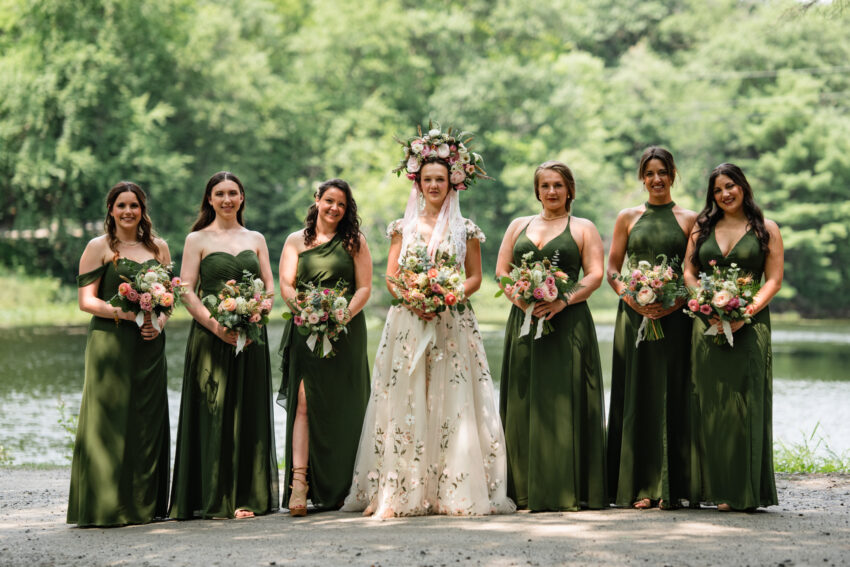 Bride and bridesmaids standing beside the lake during a wedding at Trillium Resort & Spa in Muskoka.
