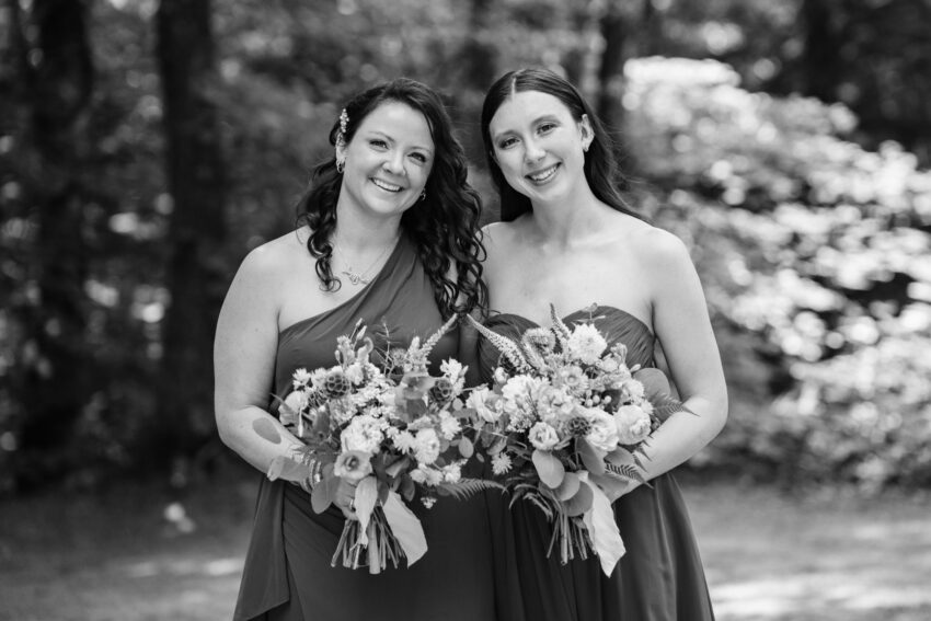 Bridesmaids holding bouquets in a black and white portrait at Trillium Resort & Spa.