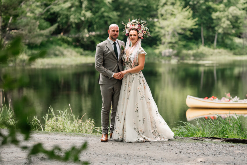 Bride and groom standing beside the lake during a wedding portrait at Trillium Resort & Spa in Muskoka.