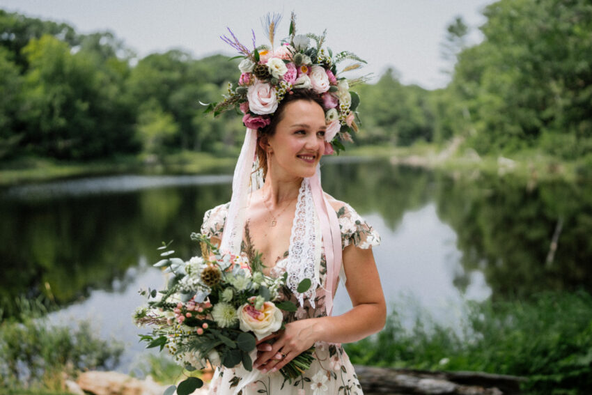 Bride holding her bouquet beside the lake during a Trillium Resort & Spa wedding in Ontario.