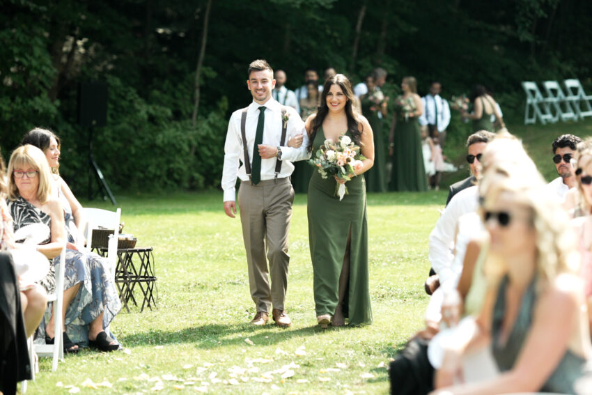 Bridesmaid and groomsman walking down the aisle during the ceremony at Trillium Resort & Spa.