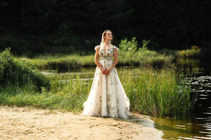 Bride standing beside the water during golden light portraits at Trillium Resort & Spa.