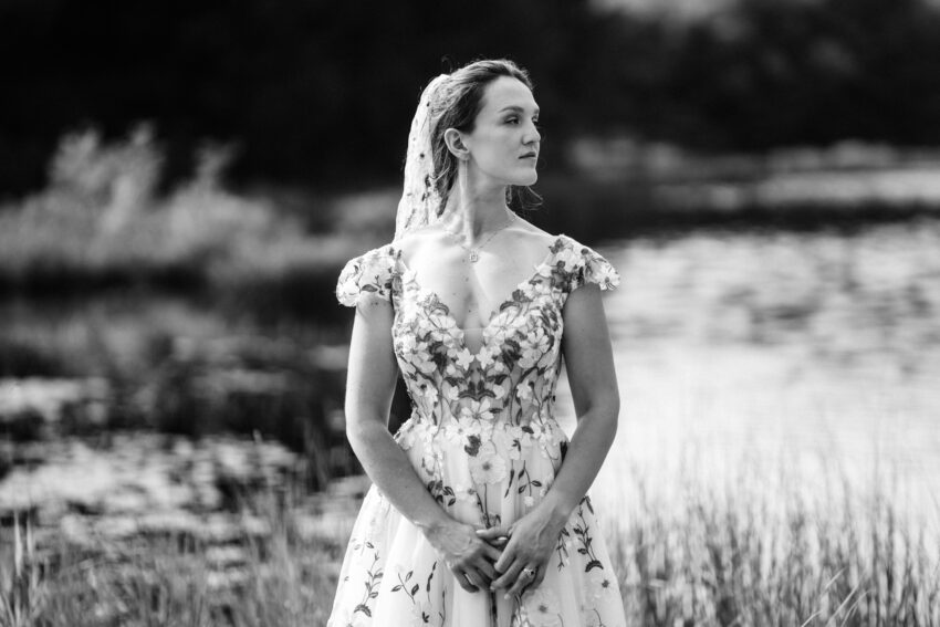 Black and white portrait of the bride beside the lakeshore at Trillium Resort & Spa in Ontario.