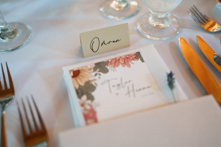 Wedding place setting with menu card and name card at the reception at Trillium Resort & Spa.
