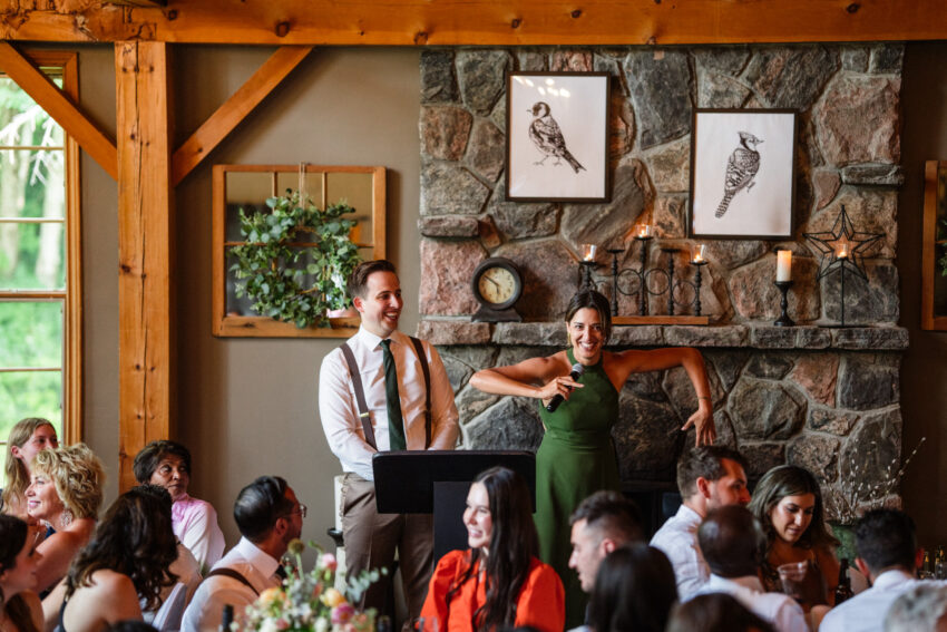 Bridesmaid speaking during the reception beside the stone fireplace at Trillium Resort & Spa.