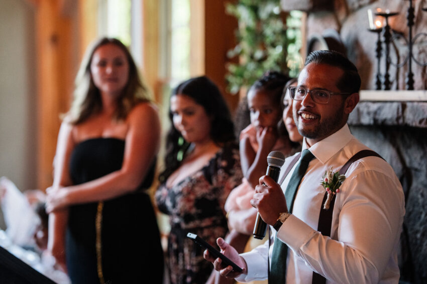 Groomsman giving a speech during the wedding reception at Trillium Resort & Spa.