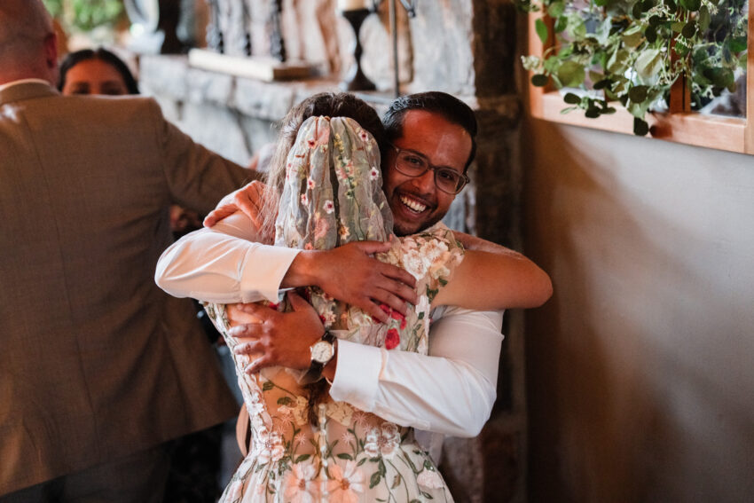 Bride hugging a guest during the reception at Trillium Resort & Spa in Muskoka.