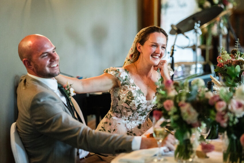 Bride and groom laughing during speeches at the wedding reception at Trillium Resort & Spa in Muskoka.