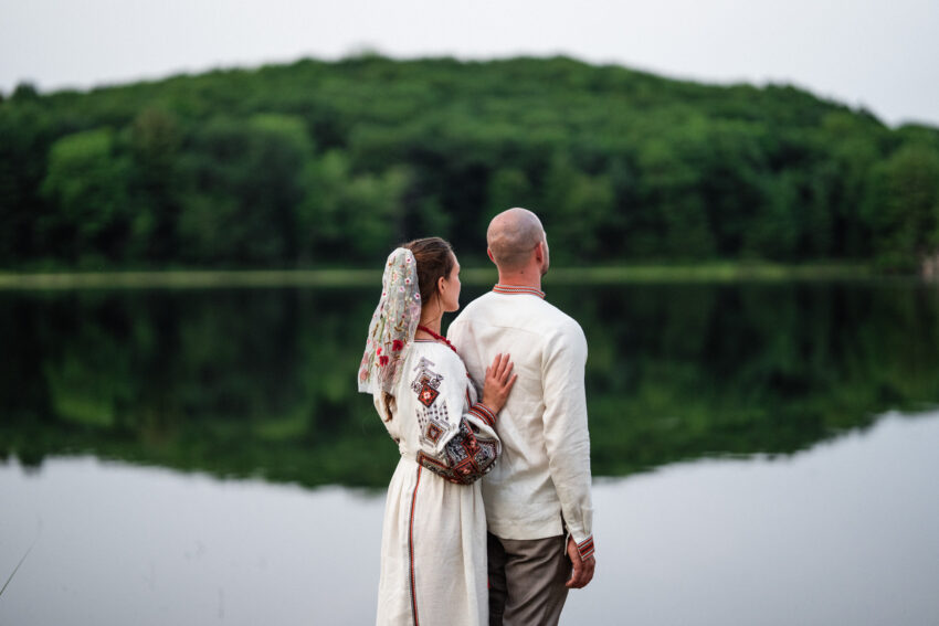 Bride and groom standing together beside the lake during evening portraits at Trillium Resort & Spa.