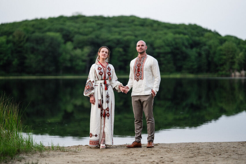 Bride and groom holding hands during lakeside portraits at Trillium Resort & Spa in Muskoka.