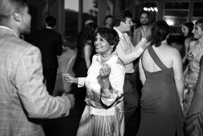 Wedding guests dancing together during the reception at Trillium Resort & Spa.
