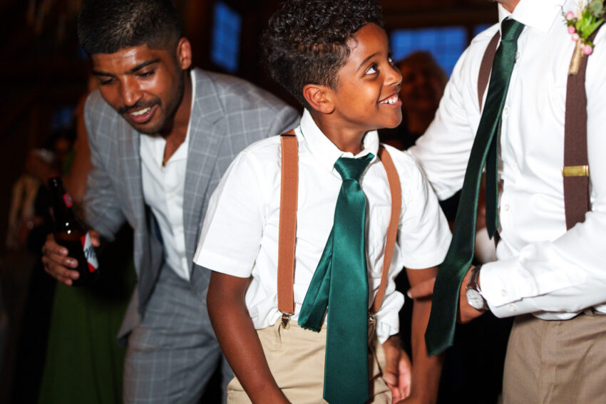 Young guest dancing on the dance floor during the wedding celebration at Trillium Resort & Spa.