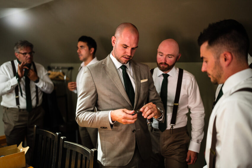 Groom and groomsmen getting ready together before the ceremony at Trillium Resort & Spa.