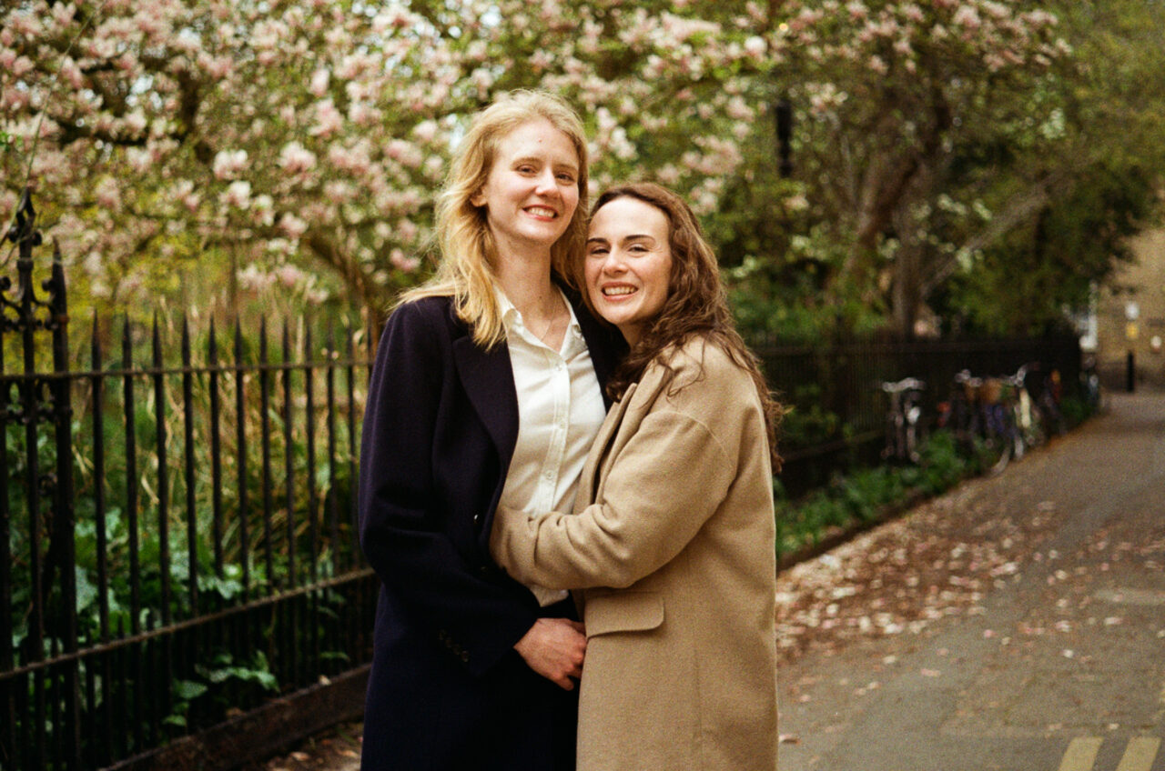 Springtime pre-wedding photo taken in Cambridge with blossom and bicycles in the background