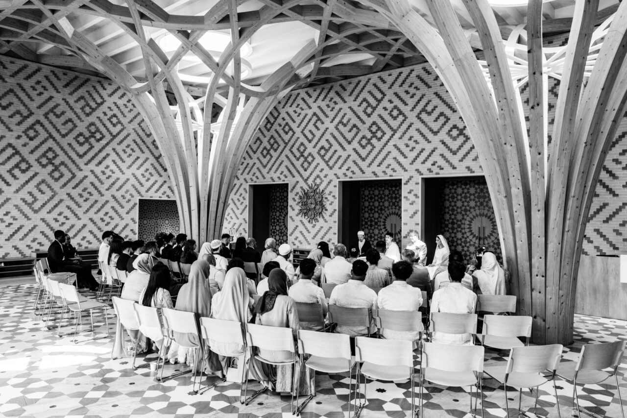 Wide angle photograph of a Muslim nikkah marriage ceremony in the main foyer of Cambridge Central Mosque.