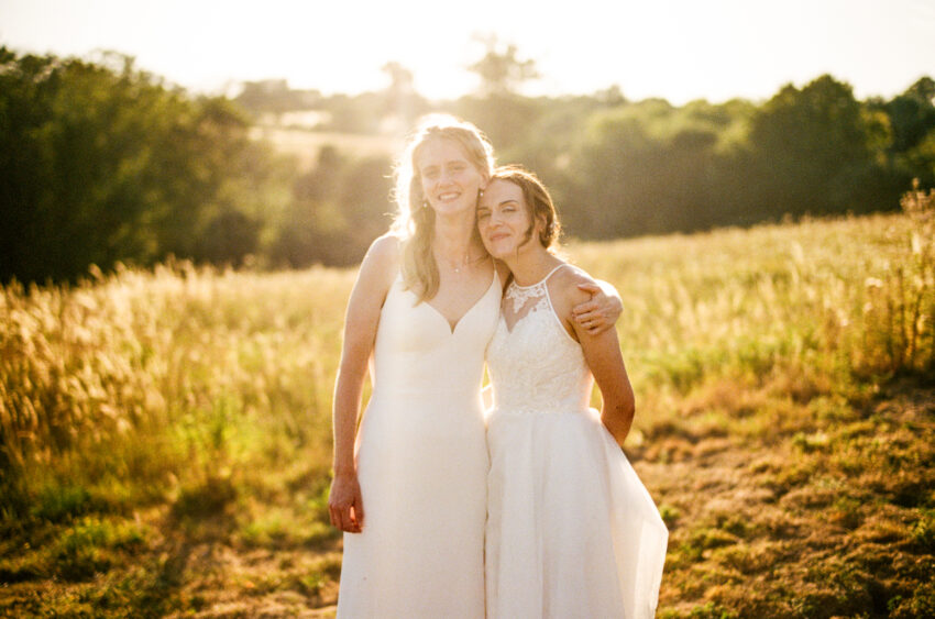 Two brides in white wedding dresses.
